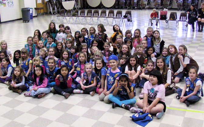 All seven Girl Scout and Brownie troops from Virginia Run Elementary gather for a group photo on the 100th anniversary of Girl Scouting.
