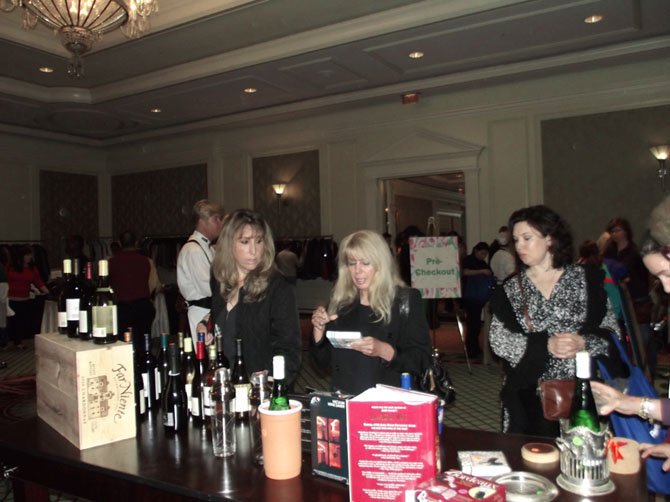 Shari Boulouri of Great Falls (left) appreciates the wine selection at The Ritz sale.