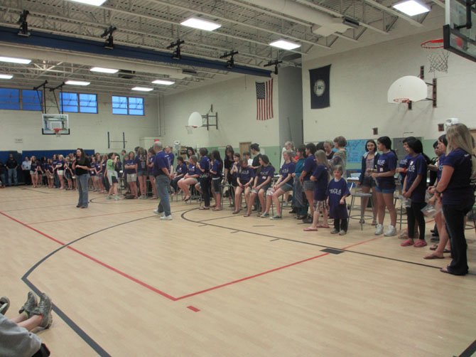 Nearly 50 purple-shirted Thoreau girls wait for the snip-and-cut to begin. They volunteered their lengths of hair on behalf of girls who lose theirs during chemotherapy.