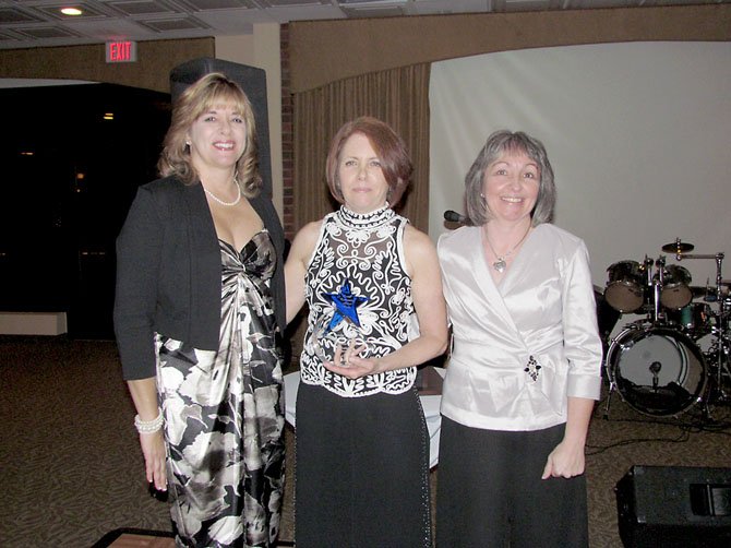 Barbara Rizer, center, stands with Lynn Swogger, LCAC’s Board President, left, and Linda Patterson, LCAC Executive Director, after receiving the Founder’s Award at LCAC’s March 10 "Spring into Action" Gala.
