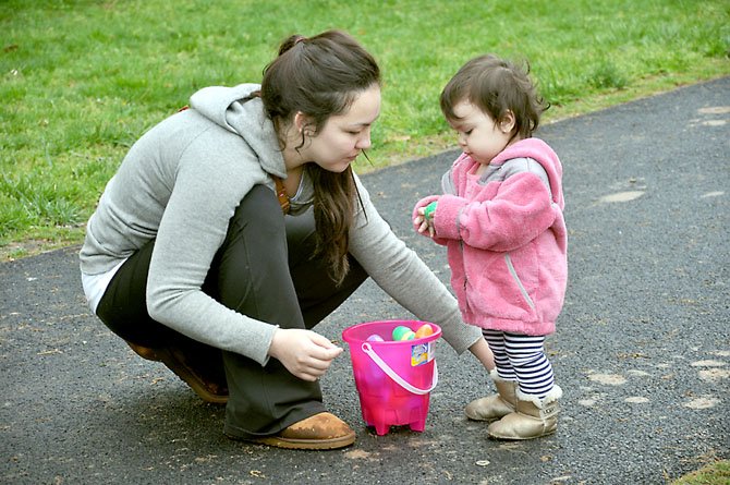 Mary Wheeler of Reston helps her 16-month-old daughter Hailey sort through her egg basket after the conclusion of the Eggnormous Egg Hunt. This year’s hunt will take place Saturday, March 31. 