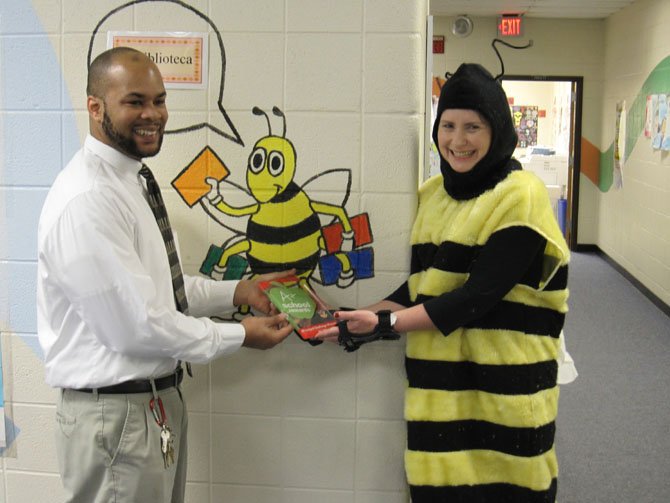 Bryan Hughes of Giant Food presents Principal Kimberly Willison with an A+ School Principal Challenge award.