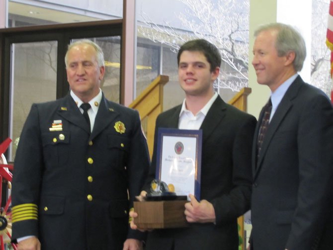 Duncan Seguin, 16, receives the “everyday hero” award from Chief Richard Bowers and Councilmember Phil Andrews.