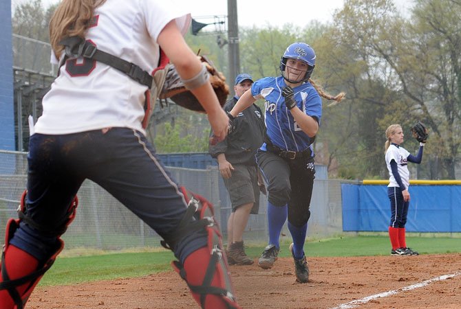 West Potomac senior Danielle McHugh rounds third and heads for home during the Wolverines’ 15-1 win against Edison on March 24.