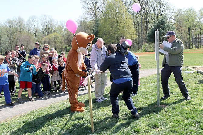 Chester the Chipmunk, the Chesterbrook Elementary School mascot, cuts the ribbon on the school’s new fitness trail Monday, March 26. 