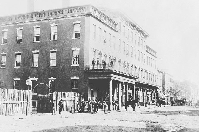 1860: This Civil War-era photograph shows the original Bank of Alexandria building on the corner. James Green turned the structure into a hotel in the 1840s and built the four-story addition on the right in 1855. 