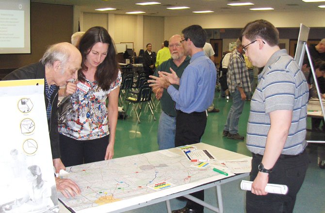 Residents discuss potential bike paths while looking at a map of the local area.