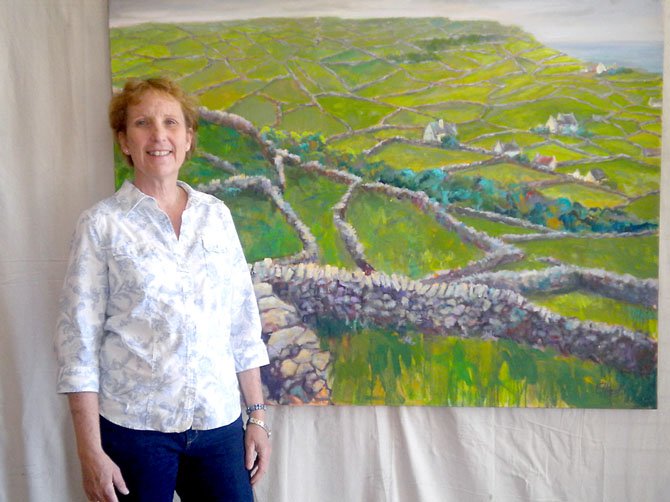 Artist Elaine Hurst and her painting “Walls of Stone.”
