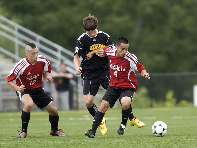 Herndon High senior midfielder Bryant Fernandez (4), shown here during the Hornets' Concorde finals versus Oakton last year, has six assists to his credit this spring.