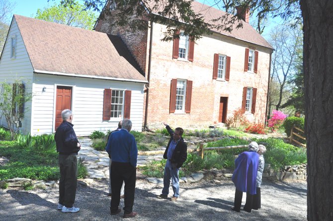 Mike Henry, manager of Colvin Run Mill, points out the miller’s house on a tour of the grounds. 