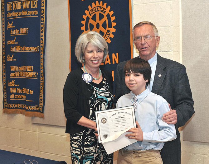 Noah Haefner, a seventh grader at Longfellow Middle School, received a Certificate of Appreciation from the Rotary Club of McLean for helping to raise $2,600 for the McLean Stop Hunger Now project. Noah (center) with McLean Rotary President Cherry Baumbusch (left) and Bob Hahne (right), a McLean Rotarian and an organizer of the McLean Stop Hunger Now project. 