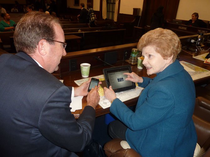 City Council members Frank Fannon and Del Pepper use an iPhone and iPad to prepare for a City Council meeting last month. Alexandria was named a Technology Solutions Award winner for its migration to cloud email services.