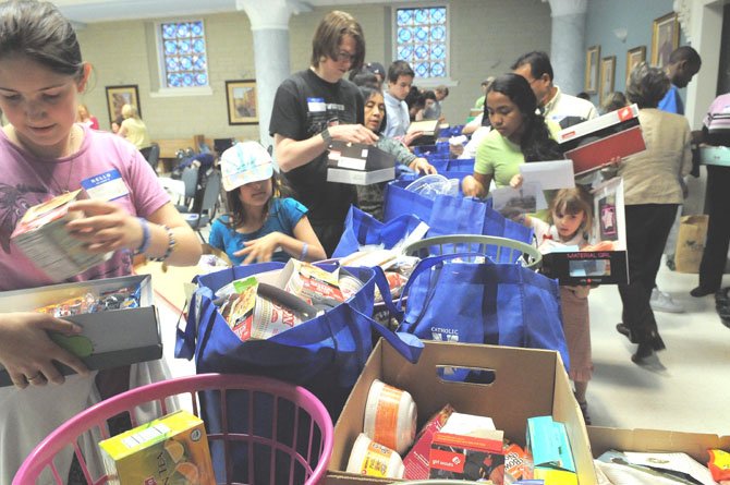 Lisa Foos (left) gathers a selection of personal items and treats for a box she has just decorated.