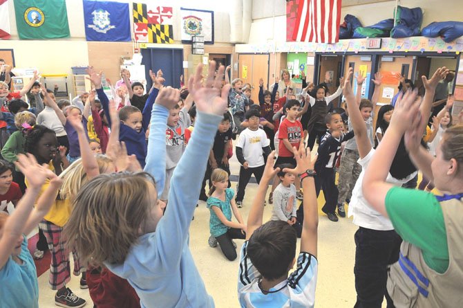 The second graders at the Arlington Science Focus School do a final tree cheer at the end of the Radio Disney program.