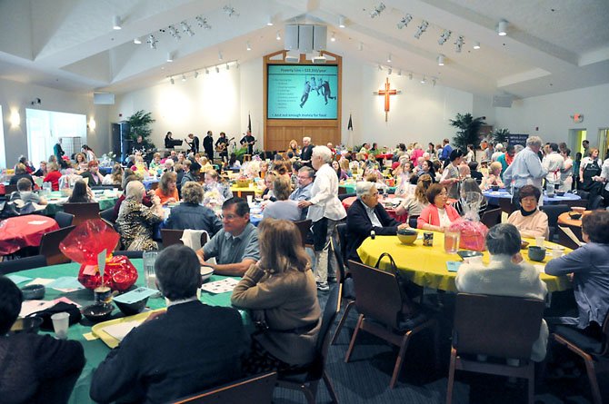 More than 500 guests dine at Floris United Methodist Church Friday, April 13 to raise money for hungry people, while a slide show with hunger facts plays. 