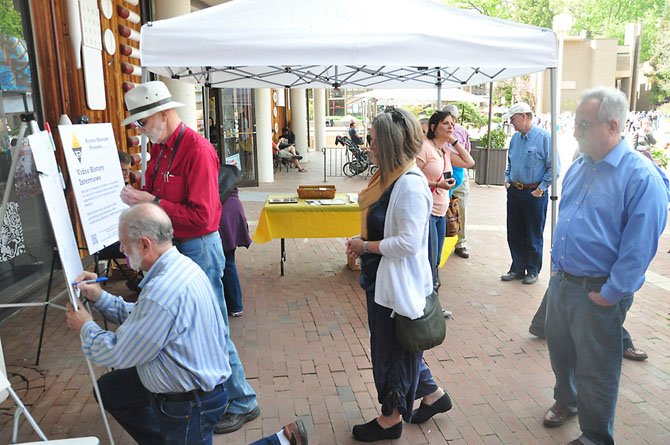 Reston residents line up to sign Reston founder Robert Simon’s birthday card in front of the Reston Museum Saturday, April 14. 