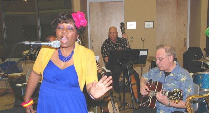 Beverly Cosham, President of the Board of Directors of the Reston Community Orchestra, sings at "Caribbean Night."

