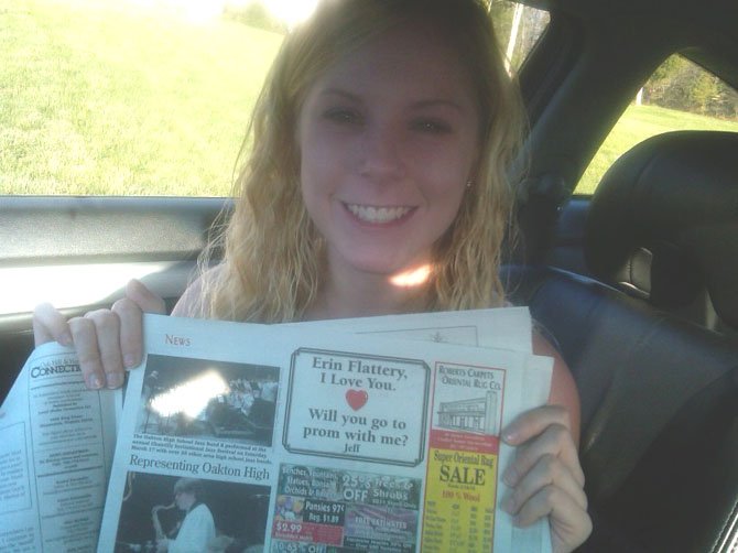 South Lakes junior Erin Flattery holds up the ad placed in The Oak Hill/Herndon Connection by her boyfriend, South Lakes senior Jeff Church, asking her to prom. Flattery happily said yes.