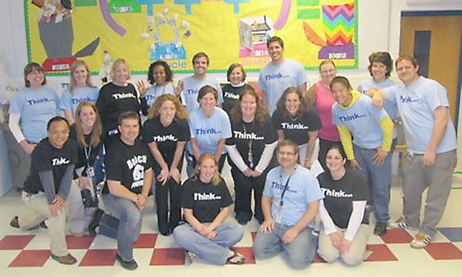 Churchill Road teachers pose "strategically" at the conclusion of a successful evening of strategy games. Pictured from left, back row: Janice Donnell, Krista Zier, Claire McHale, Sharon Jones, Nick Kilpatrick, Jan Clark, Joshua DeSmyter, Sarah Winn, Lisa O'Donnell; (front row) Jinhai He, Jaime Lofurno, Bob Timke, Corinne Almquist, Cindy Zemke, Sarah Finger, Cheryl Bamdad, Dustin Lee and Jordan Craig-Kuhn; (seated in front) Jill Hamlin, Mike Romanelli and Jennifer Ezzell.