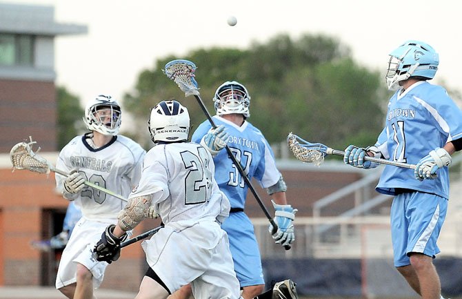 Yorktown boys’ lacrosse captains Josh Fleetwood (31) and Jack Maher (11) were part of a defensive effort that held Washington-Lee scoreless for a stretch of 32-plus minutes on April 19.
