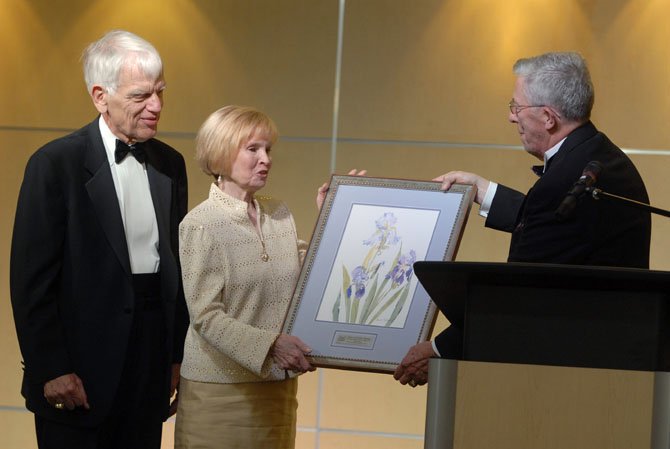 Former City of Fairfax Mayor John Mason presents a gift to retiring George Mason University President Alan Merten and his wife, Sally, at the City of Fairfax Mayor’s Ball on Friday evening. The Mertens were honorary co-chairs for the event, to honor their service to the Fairfax community and for the arts.