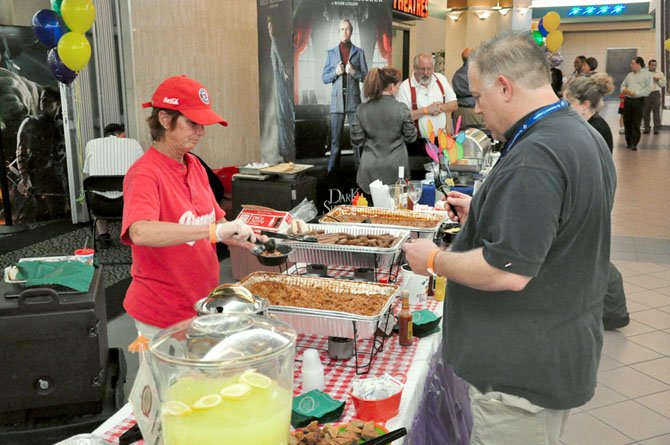 Buzz Rider samples some jambalaya from Jimmy’s Old Town Tavern during the annual Taste of the Town event at Worldgate Thursday, April 19. 