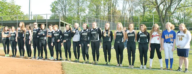 Former Great Falls Little Leaguers, now competing as high school softball players, were attired in their bright, colorful school team uniforms as part of the Opening Day festivities. 