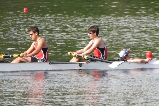 With Mark Comey in the coxswain seat, rowers Greg Montenegro, left, and Henry Anderson, right, help power the T.C. Williams boys’ varsity 4 crew team toward the finish line in their morning heat at the Smokey Jacob Regatta on April 21. The varsity 4 won the heat and then took second place in the final, finishing just .62 seconds behind the winner.