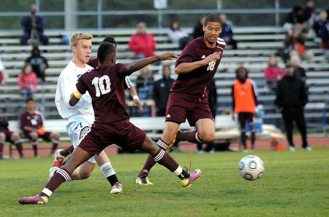 Mount Vernon junior Simond Kargbo (10) goes for the ball as junior Rahim Costa-Dorsey (18) comes toward the play on April 24.