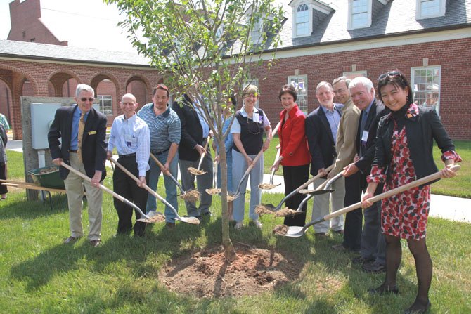Cherry tree donors plant the first tree, as part of the official cherry tree planting celebration at the Workhouse Arts Center, Saturday, April 21, 2012."