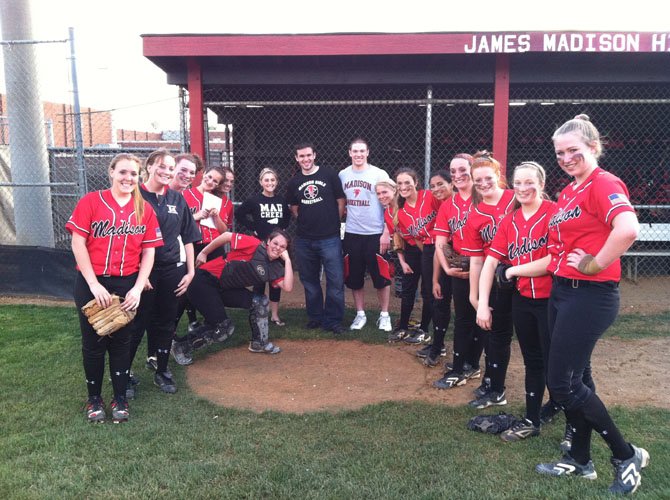 Madison High teachers (center, back) Colleen McAuley, Dan Grossman, and Mike Bath pose with members of the Madison softball team last Friday evening prior to pre-game `Teacher Night’ festivities. A fourth Madison teacher, Ryan Douds, was unable to attend the evening’s ceremonies.