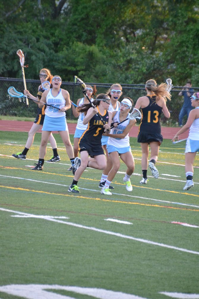 Langley High senior co-captain Kelly Martins (5) rushes the goal during the Saxons’ recent Liberty District game versus Marshall.