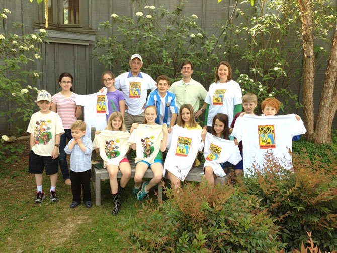 Ian Roberts, back left, chairman of this year's Mount Vernon/VIC CROP Hunger Walk on May 6, checks out this year's CROP T-shirts with young people from St. Aidan's Episcopal Church, 8531 Riverside Road, Alexandria, site of this year's walk. Wynne Kelch, back right, a St. Aidan's Walk captain and pictured with her husband Greg, helps rally all of the Mount Vernon walkers for major fundraising support.
