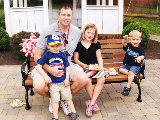 Chilling on the newly dedicated bench are Quinn McGrael, daughter Abby, 7, and twin sons Aidan (on left) and Evan, 3. (Not pictured is mom Wendy.)
