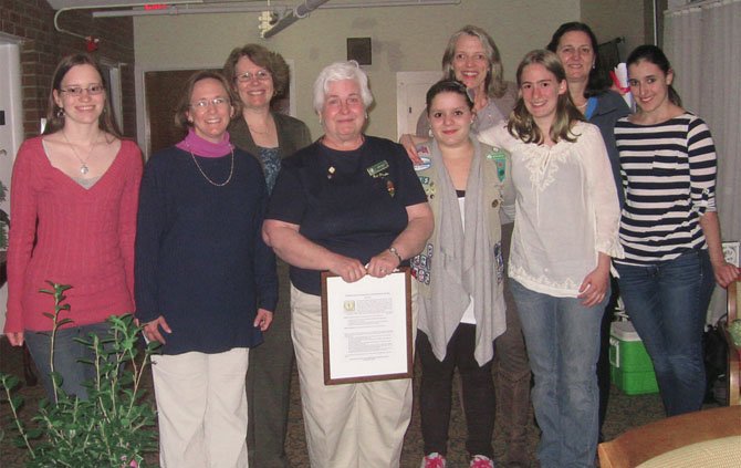 Linda Kelly, fourth from left, is honored April 23 for her outstanding Girl Scout Leadership. Celebrating with her are Girl Scout Ambassadors Maggie Johnston, Natascha Zelloe, Sarah Laane, and Jackie Pastore, surrounded by Adult Volunteer Pat Laane, Service Unit Manager Gretchen Schreiber, Assistant Troop Advisor Monika Hoffarth-Zelloe and Cookie Manager Karen Helbrecht.
