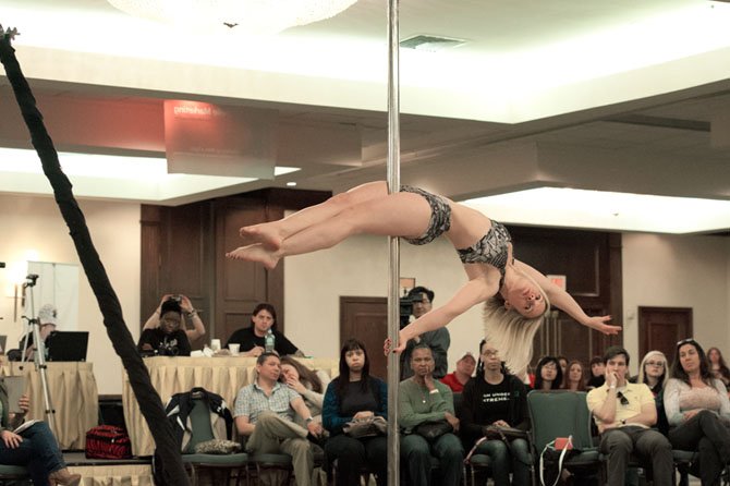 Mary Flemming of Chantilly, a competitor in the Ms. Virginia Pole Dance America Fitness Competition on April 28 at the Crystal City Hilton, demonstrates extreme strength, flexibility and stamina during her routine in the compulsory round.
