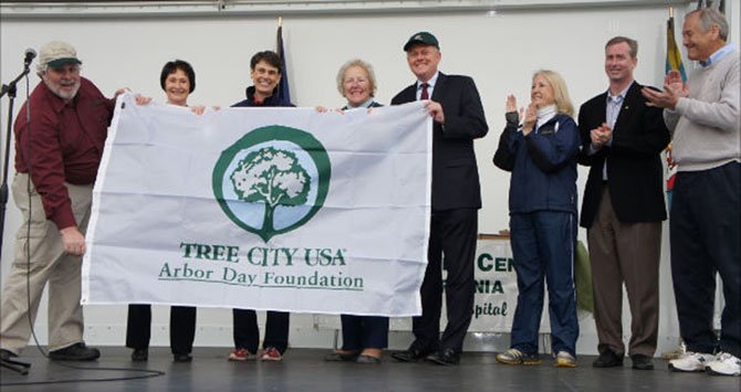 Fairfax County does it again – from left: The 2012 Tree City USA Banner is unfurled by Jim McGlone of the Dept. of Forestry, Sharon Bulova, Chairman of the Fairfax County Board of Supervisors (D-At-Large), Supervisor Linda Smyth, Providence District, Supervisor and Vice Chairman Penny Gross, Mason District, Supervisor John Cook, Braddock District, Virginia General Assembly Delegates, Vivian Watts, (D-39) and David Bulova (D-37) and State Senator David Marsden (D-37).