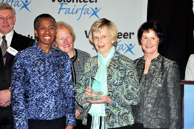 Members of the Fairfax County Board of Supervisors present Marilyn Silvey of the United Christian Parish with a Volunteer Service Award on behalf of her organization. 