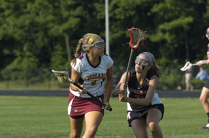 Oakton's Kelsey Clarke, with the ball here in last year's state finals versus Madison, has been one of the Cougars' top players this spring.