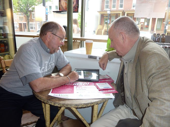 ACT for Alexandria Executive Director John Porter, left, demonstrates the Spring2Action online donation program to Peter Dingman May 2 at the Uptowner CafÈ. The 24-hour online giving initiative benefitted more than 70 local charities and served as the kick off to the 2012 Spring for Alexandria events taking place May 3-5. For more information on the schedule of events, visit www.springforalexandria.org.
