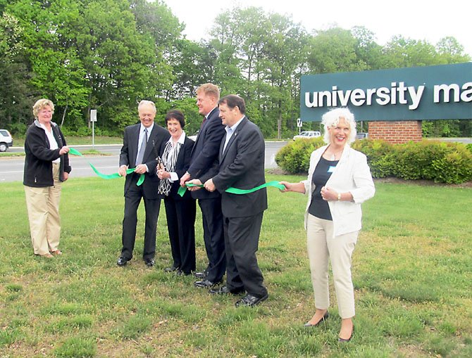 Ribbon-cutting in May, shovel-ready in June: From left, Sallie Brodie, chairman of the George H. Rucker Realty Corporation (GHRRC) helps to cut the ribbon on the $30 Million University Mall expansion and renovation project during a ceremony on Saturday, April 21, with Richard Wolff, president and CEO of GHRRC; Fairfax County Board of Supervisors Chairman Sharon Bulova; Braddock district Supervisor John Cook; Springfield district Supervisor Pat Herrity; and Kathleen Whatley, one of the project partners. 