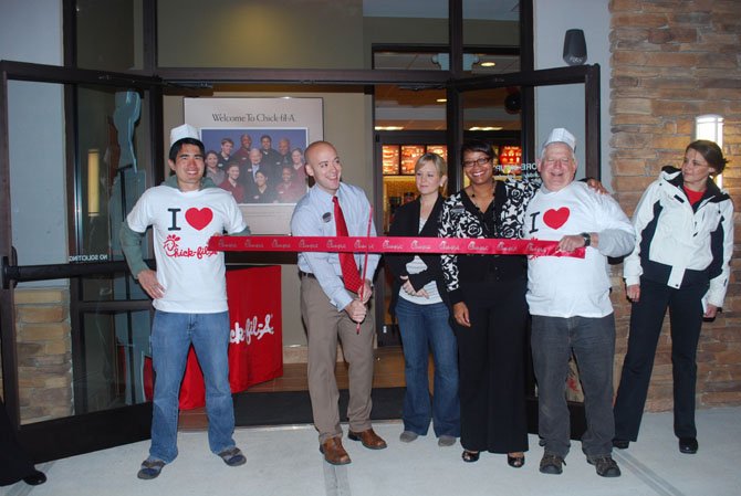 From left: Scott Inouye, number one of the first 100 in line; Joe Engert, owner of Chick-fil-A, cutting the ribbon; Daniel Engert, Joe's wife; Juliet Hall, business consultant of Chick-fil-A; and Gerry Webb, number 100 from the first 100 in line. 