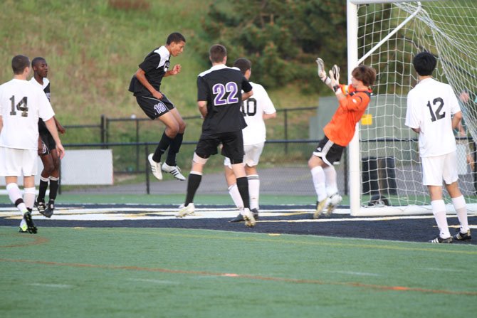 Chantilly sophomore Nick Ullom, in the air, scores on a header shot to give the Chargers an early 1-0 lead over Westfield. Chantilly, in the Concorde District game played on April 26 at Westfield, went on to win 4-0. No. 22 for Chantilly is senior midfielder Anton LeKang.