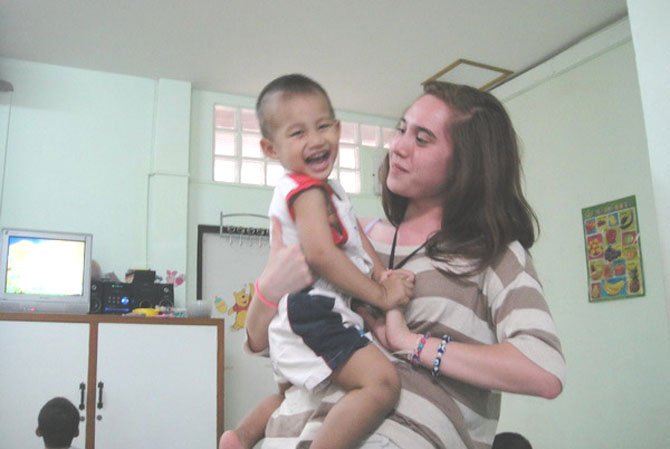 Charlotte sharing a laugh with 3-year-old orphan "Wichian."