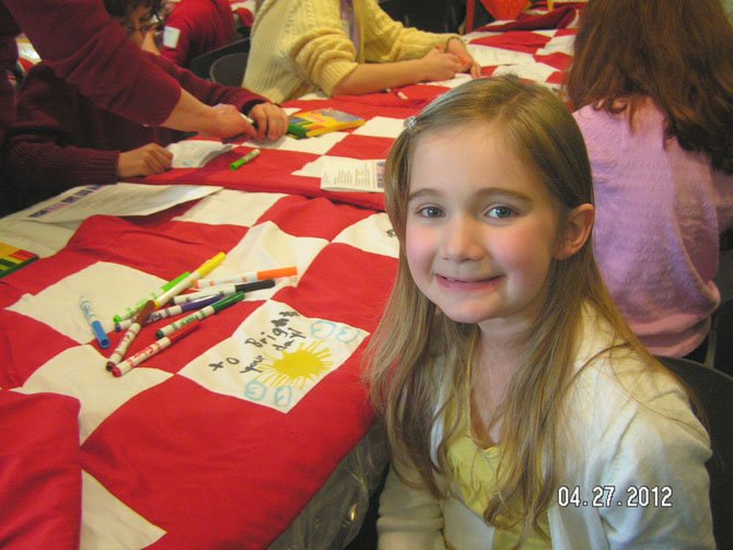 Children of Sallie Mae employees celebrate and take part in decorating the blankets.