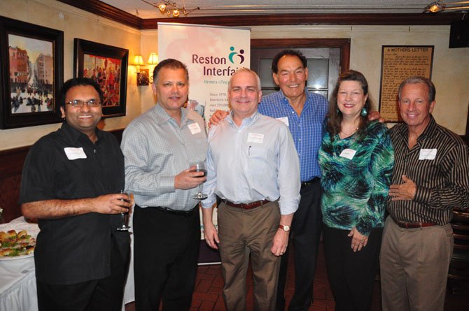 From left, Reston Smile Partners Members Sumit Sharma, Luis Martinez, Charles Fields, Frederick Dibbs, Joan Wise of Reston Interfaith and Joseph Richardson at a fundraiser at The Old Brogue Tuesday, May 1. 