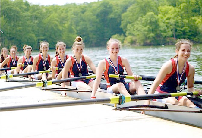 The T.C. Williams girls’ freshman 8 are seen at the dock at the Ted Phoenix Regatta on May 5 after being awarded the silver medal as one of the two top boats in the Commonwealth of Virginia. Members of the freshman 8 include (from left): Zoe Gildersleeve, Rachael Vannatta, Taylor Sanders, Maura Nakahata, Claire Embrey, Margaret McVeigh, Kyra McClary, and Maeve Bradley. Sitting in front of Bradley, just outside the picture, is coxswain Kathrina Policarpio.