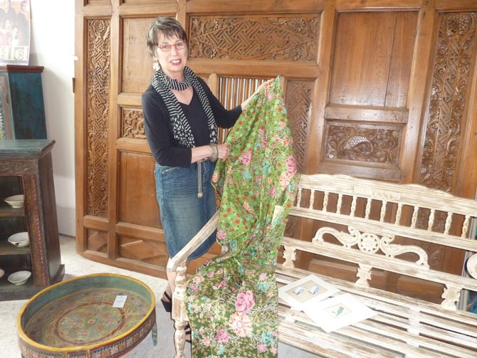 Banana Tree owner Monique Bergin display a batik at the 'pop up' sale on Mount Vernon Avenue in Del Ray.
