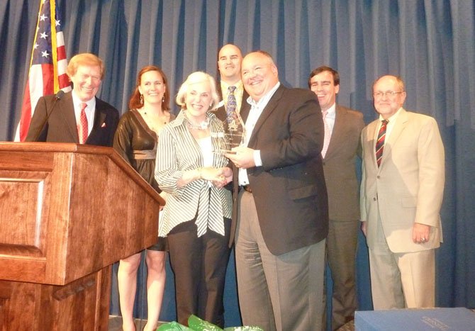 Leslie Ariail, front right, accepts the Legacy of Giving Award from Andrew Blair on behalf of the Ariail family. Standing behind her are WJLA meteorologist Bob Ryan, daughter Allison Erdle, John Ariail III, Shreve Ariail and ACT Executive Director John Porter.
