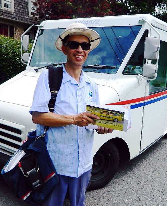 Postal carrier David Yip says he doesn’t mind the extra work involved in collecting donated food.
